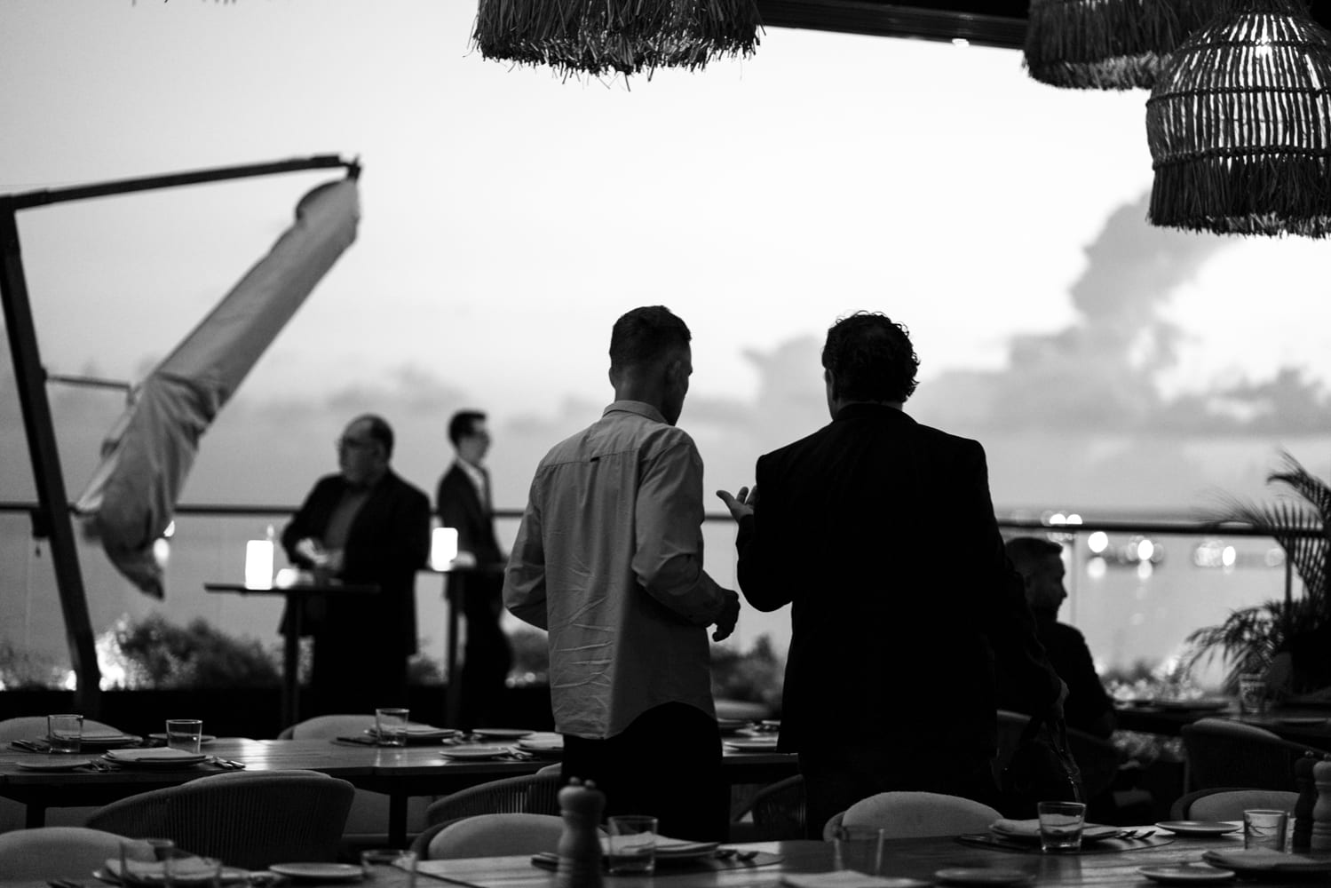 Investors and founders talking at a Doers dinner at dusk