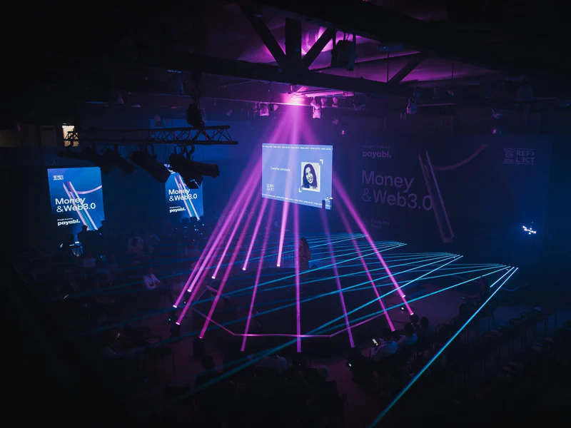 Magenta lasers fanning out over a dark stage