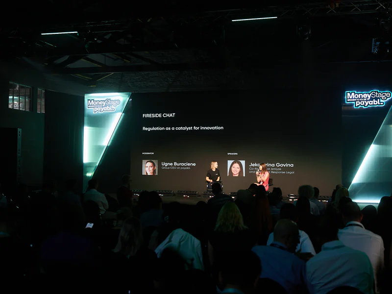 A panel discussion, the speakers’ portraits on the screen behind them
